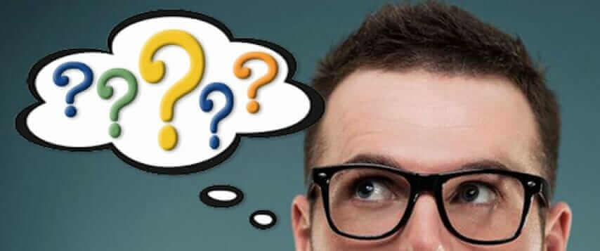 Man with glasses pondering FAQs, colorful question marks in thought bubble.