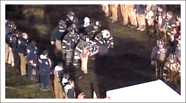 Emergency responders in uniforms gather at night, highlighting teamwork and rescue efforts.