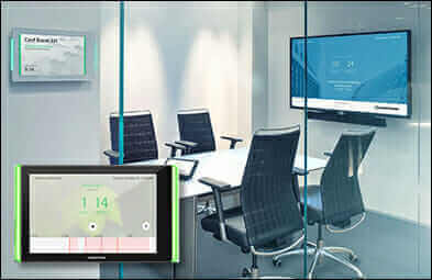 Modern conference room with digital scheduling screens, glass walls, and ergonomic chairs for efficient room booking.