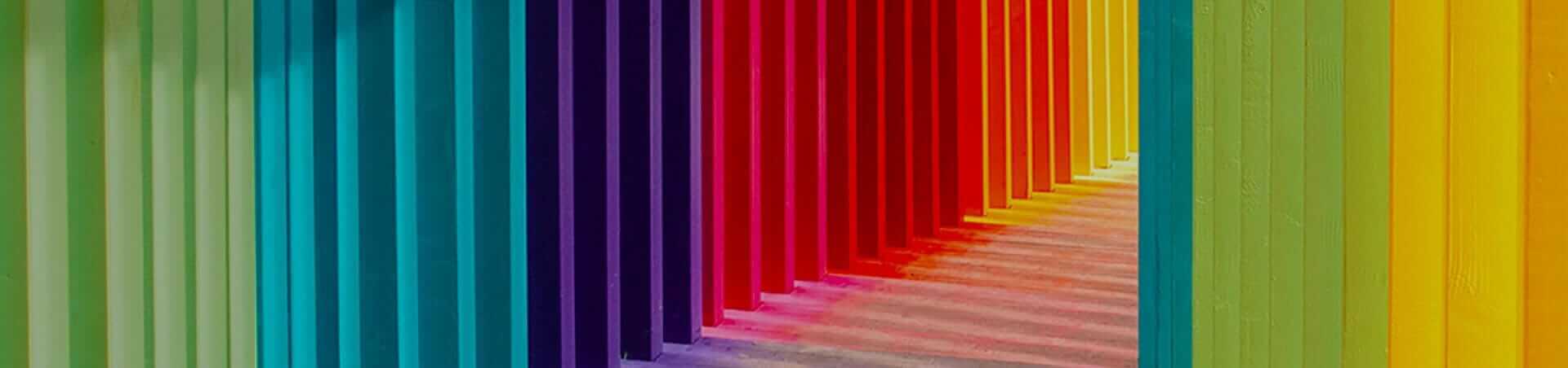 Colorful corridor with vibrant rainbow stripes, perfect for AV industry event banner design and creative visual marketing.
