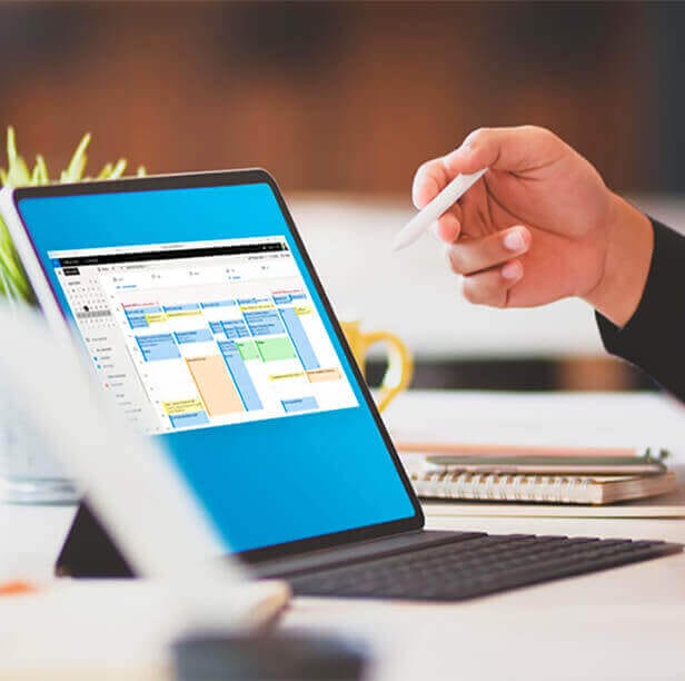 Tablet displaying Condeco scheduling software interface, with hand holding stylus, emphasizing digital workspace management.