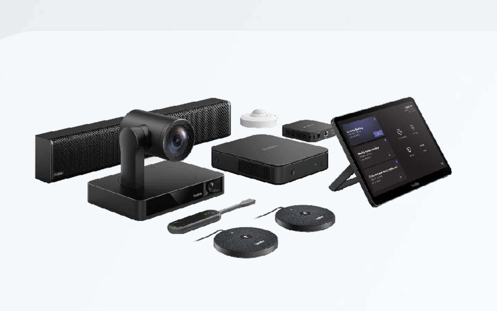 Video conferencing equipment set, including camera, soundbar, control panel, and microphones for conference rooms.